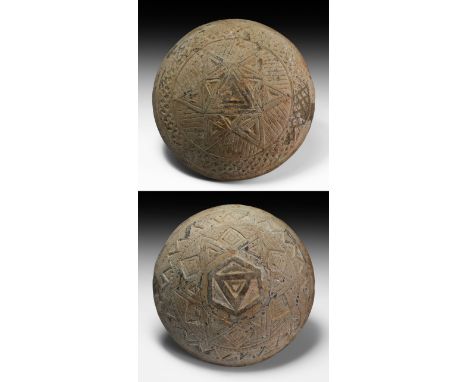 1st millennium AD. A ceramic biconvex disc with concentric bands of impressed geometric patterns, hexagon and star motifs to 