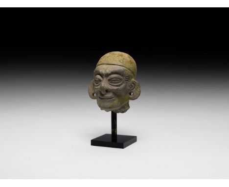 500 BC-500 AD. A ceramic model head with tight-fitting cap; nose and ears pierced for attachment of rings or other ornaments;
