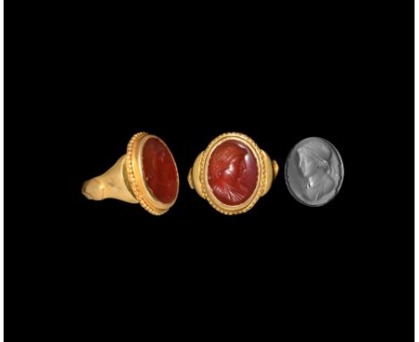 3rd-4th century AD. A carnelian gemstone with intaglio bust of a youthful male (Apollo?) with his hair held by a filet; set i