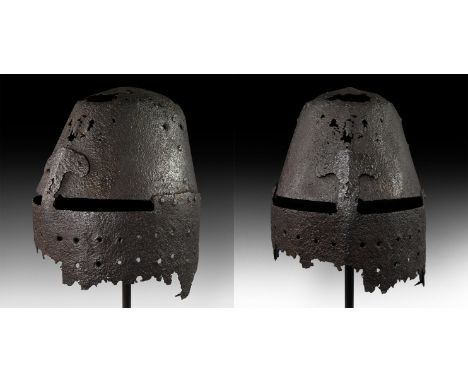 Mid 14th century AD. A German great helm of later type with the lower part missing, but still visible in its original shape; 