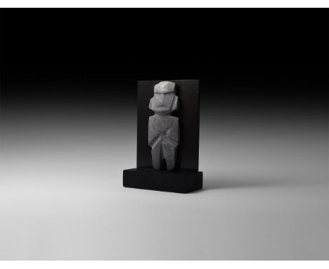 200 BC. A carved limestone figure with angular facial and bodily detailing, facetted head and trunk; mounted on a custom-made