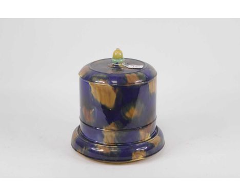 A Victorian majolica glazed cheese dome and cover, on a mottled blue/brown ground with acorn finial, h.31cm