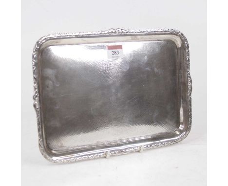 A George V silver dressing table tray, of rectangular form, having engine turned decoration within repousse decorated border,