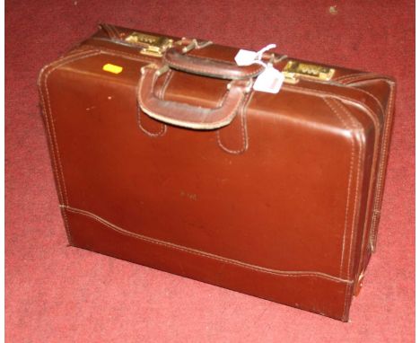 A vintage brown leather briefcase, having twin handles and twin combination locks, opening to reveal fitted interior, w.45cmH