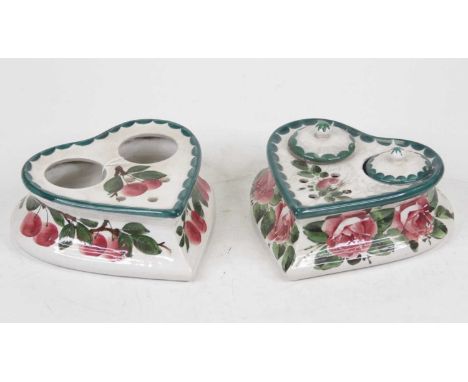 A Wemyss ware inkwell, of heart shape, hand-painted with pink cabbage roses, with two covers for ink bottles and four pen ape