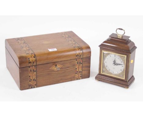 A walnut cased mantel clock in the 18th century style, having a silvered chapter ring with Roman numerals and Arabic outer nu