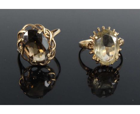 A modern 9ct gold smoky quartz set dress ring, size P; together with a modern 9ct gold and citrine set dress ring, size M, gr