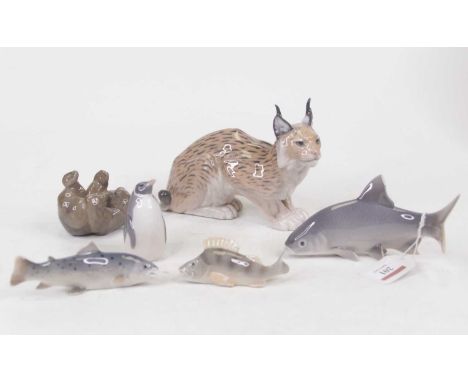A Royal Copenhagen porcelain model of a Lynx in recumbent pose having printed mark verso, numbered 1329, height 12cm, togethe