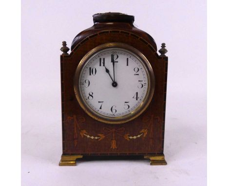 An Edwardian mahogany cased mantel clock, the enamel dial showing Arabic numerals with inlaid swag and bow decoration, height