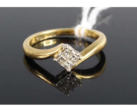 A modern 18ct gold diamond crossover ring, arranged as four Princess cuts in a square setting, total weight stated as 0.15 ca