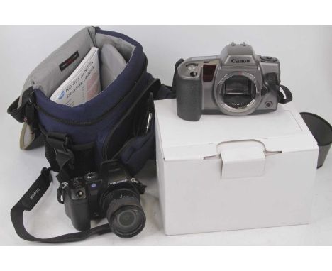 A Konica Minolta Dimage A200 digital camera; together with a Canon camera body; travelling case and accessories 