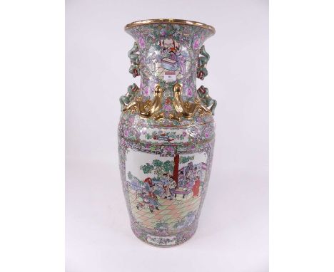 A large Chinese Canton export floor vase, having everted rim to a baluster body, with shi-shi handles, enamel decorated in th