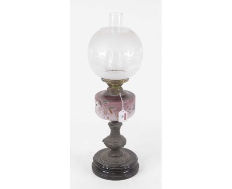 A Victorian oil lamp, having an opalescent etched glass globular shade above a purple tinted glass font hand-painted with flo