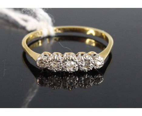 An 18ct gold platinum and diamond five stone ring, arranged as five illusion set small graduated round cuts 1.7g, size M