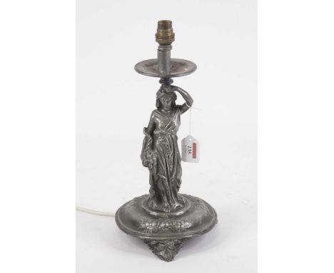 An Art Nouveau figural table candlestick, the single sconce supported by a robed maiden with basket of fruit in hand, on dome