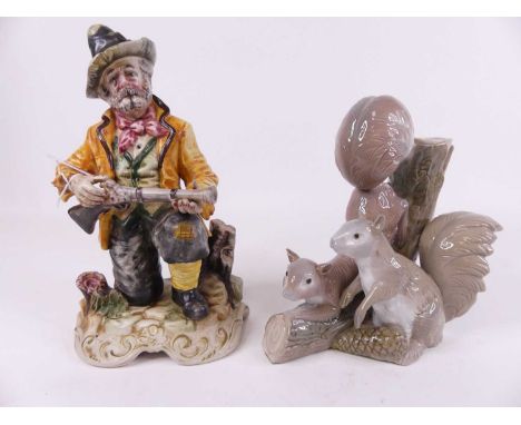 A Capo di Monte figure of a man kneeling holding a blunderbuss, height 30cm, together with a Spanish porcelain figural vase i