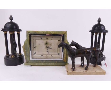 A bronzed figure group of two horses standing on a polished marble plinth, height 16cm, together with two clock garnitures an