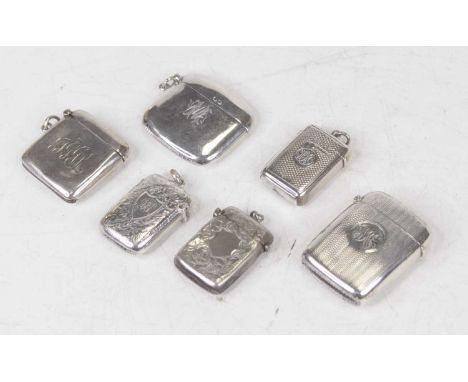 A late Victorian silver vesta, of rectangular form, having engine turned decoration and monogrammed cartouche; together with 