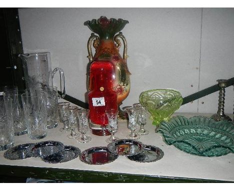 A shelf of assorted glass ware.