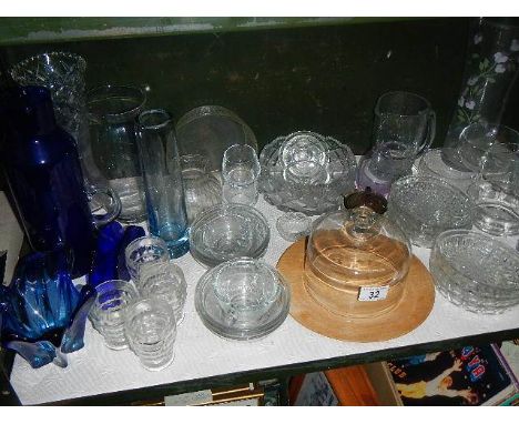 A shelf of assorted glass ware.