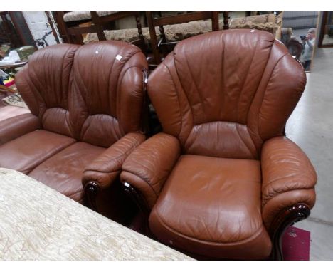 A tan leather 2 seat sofa and chair.