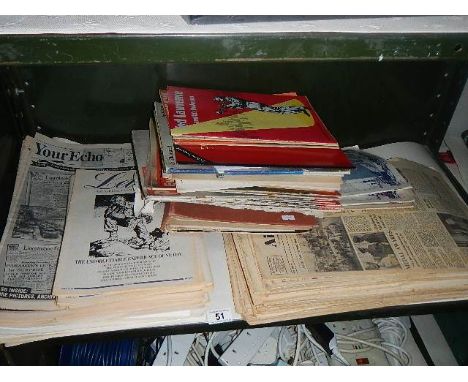 A shelf of old newspapers and magazines.