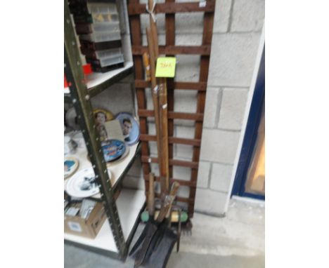 A collection of garden tools and a trellis