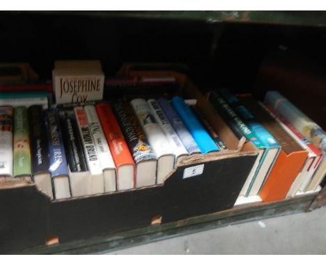 A shelf of mainly hardback books.