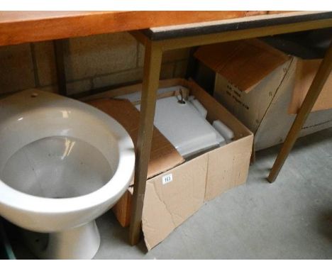 A new modern wash basin and 2 toilets.