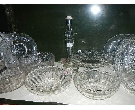 A shelf of glassware including bowls, commemorative plates, cake stand etc.,