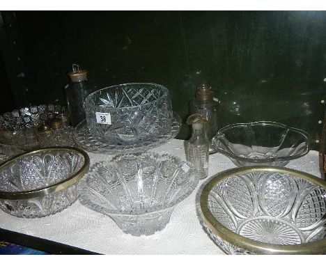 A shelf of assorted glass ware.