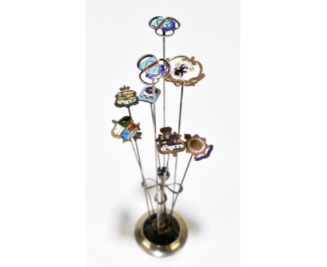 CHARLES HORNER; a hat pin stand containing seven enamel decorated hat pins, one inscribed&nbsp; 'Army Service Corps'.Addition