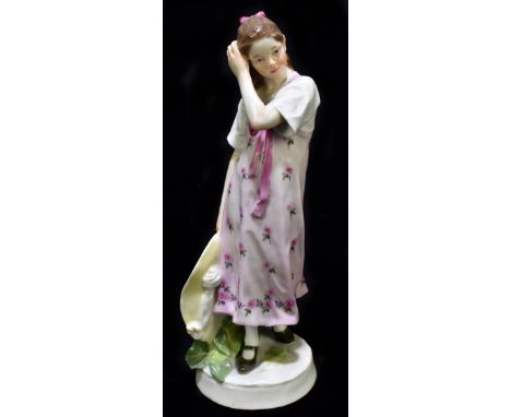 MEISSEN; a 20th century figure of a young girl holding a wide brimmed hat in her right hand, painted marks to base, also pain