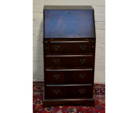 A reproduction mahogany bureau, the fall front enclosing pigeon holes and drawer, above four drawers, raised on bracket feet,