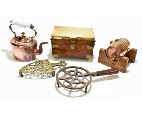 An early 20th century brass bound tea caddy of rectangular form, with applied shield cartouche, the hinged cover enclosing tw