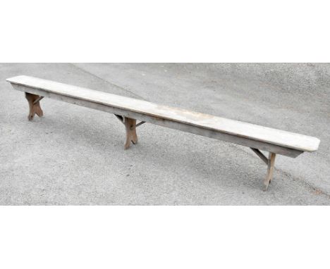 A rustic pine bench of long proportions, length 335cm.Additional InformationThis item is in barn find condition and has gener