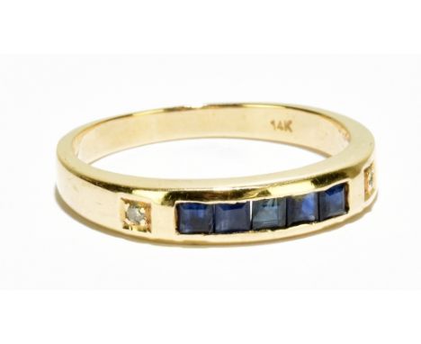 A 14ct yellow gold sapphire and diamond ring, with five square cut sapphires totalling approx. 1ct and two tiny diamonds eith