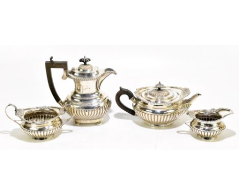 GEORGE NATHAN &amp; RIDLEY HAYES; a George V hallmarked three piece tea service with cast open shell and scrolling rims above