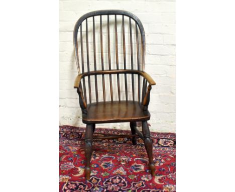 A 19th century beech and ash country kitchen Windsor chair, with spindle back and saddle seat, on turned legs, height 108cm.A