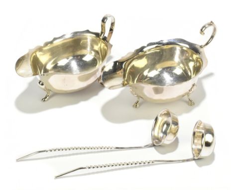 JAMES CARR; two hallmarked silver sauce boats with cast edges, one example raised on hoof feet, Birmingham 1932-36, each with