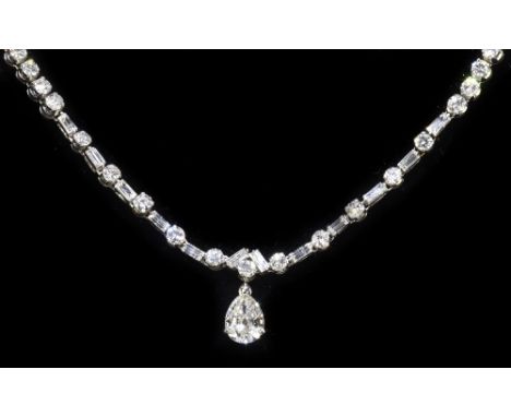A fine French white metal and diamond set necklace, the pear shaped diamond drop weighing approx. 1.80cts, with a framework o