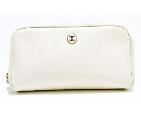 CHANEL; a cream textured leather make up bag with zip top, gold tone enamel maker's logo to front, lined with monogrammed can