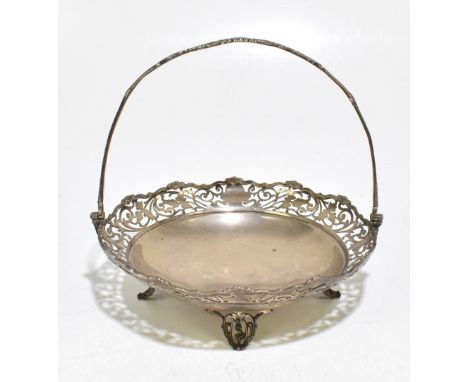 JOSIAH WILLIAMS &amp; Co; a George V hallmarked silver swing handled bowl with pierced border, raised on four swept feet, Lon