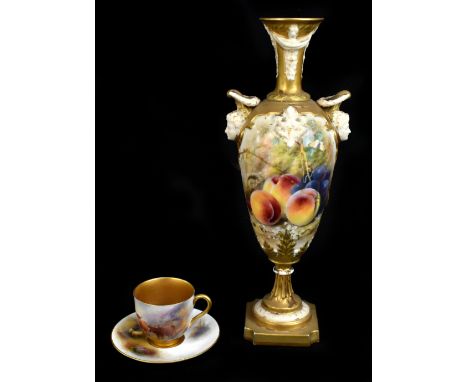WILLIAM RICKETTS FOR ROYAL WORCESTER; a large hand painted pedestal vase with moulded mask head handles, decorated with fruit