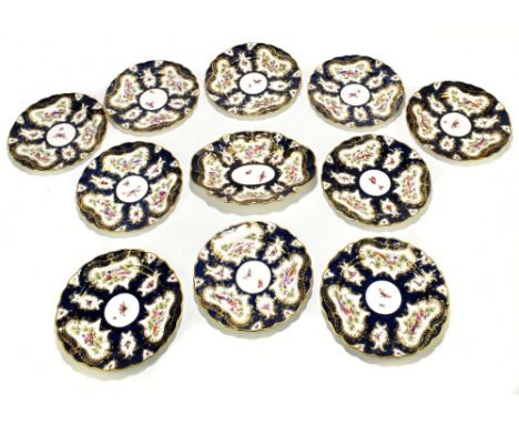ROYAL WORCESTER; an eleven piece part dessert service decorated with exotic birds and insects inside a bat wing cobalt blue, 