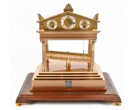 THWAITES &amp; REED; a large and impressive gilt metal rolling ball clock of architectural form with three applied chapter ri