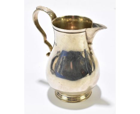 GOLDSMITHS &amp; SILVERSMITHS LTD; a George V hallmarked silver sparrow beak cream jug of baluster form, London 1919, height 