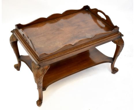 A reproduction mahogany tray table with detachable twin handled tray, raised on carved cabriole feet, width 73cm, depth 49cm,