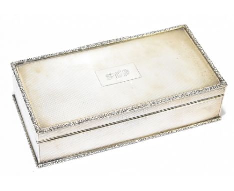 H PIDDUCK &amp; SONS; a George V hallmarked silver cigarette box with cast edge and engine turned body, with cedar wood inter