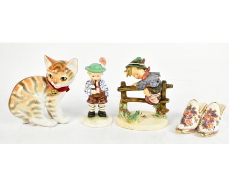 GOEBEL; a figure group with a boy climbing a fence beside a frog, height 14cm, together with a Russian ceramic figure of a ca